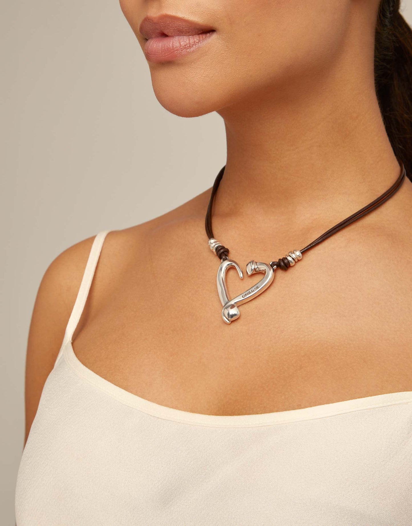 Silver pendant with 2 leather straps and heart