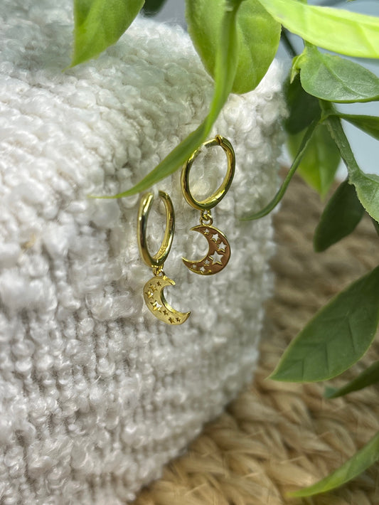 Gold plated hoop earrings feature crescent moon charms with star cut-outs
