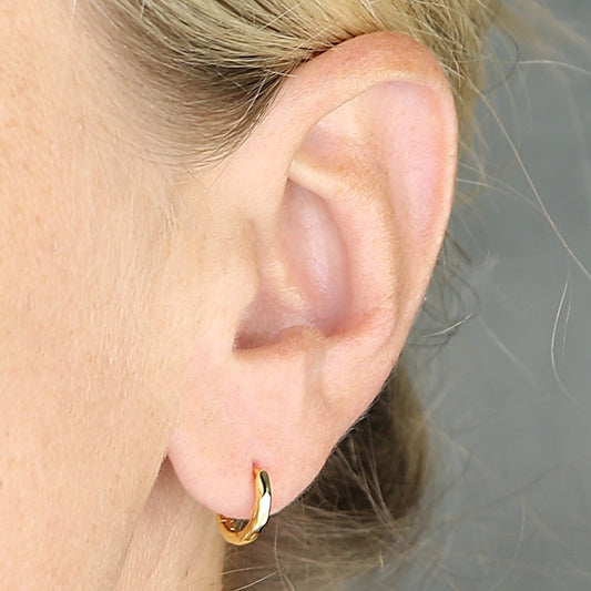 Yellow gold-plated, 10mm hinged-hoop with soft faceted detail.